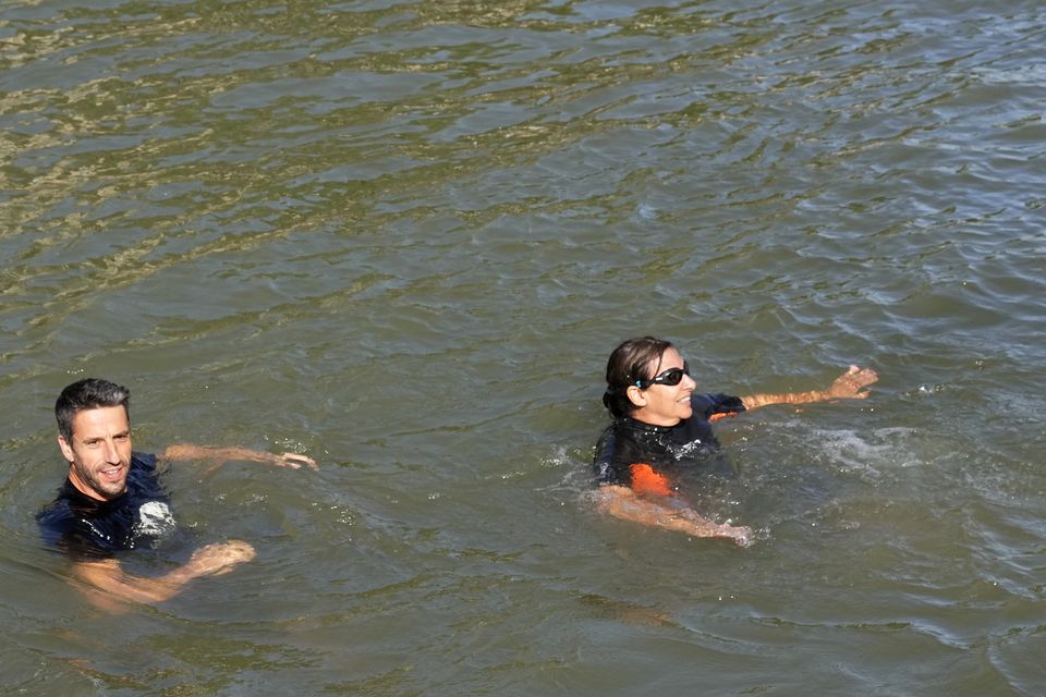 Tony Estanguet, president of the Paris 2024 Olympic and Paralympic Games Organising Committee, joined Ms Hidalgo in the water (AP)