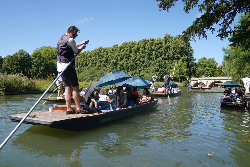 People enjoy punt tours along the River Cam in Cambridge (Joe Giddens/PA)