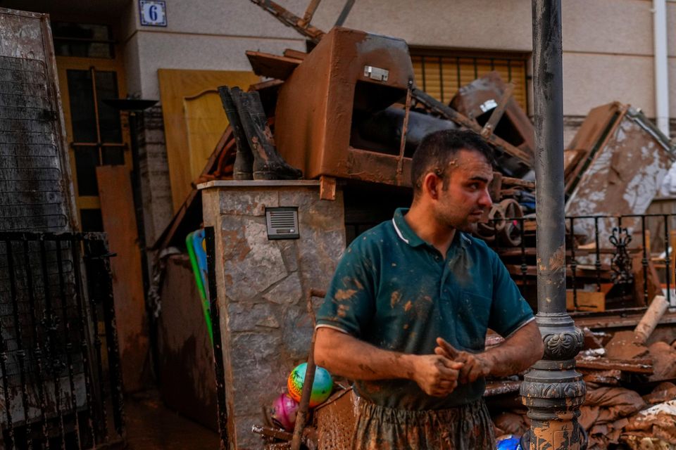 People clean their houses affected by floods in Utiel (Manu Fernandez/AP)