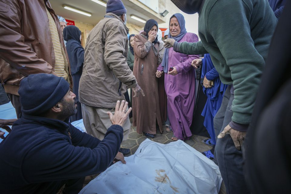 Relatives mourn as the bodies of victims from overnight Israeli army strikes are laid together for funeral prayers at Al-Aqsa Martyrs Hospital in Deir al-Balah, Gaza (Abdel Kareem Hana/AP)