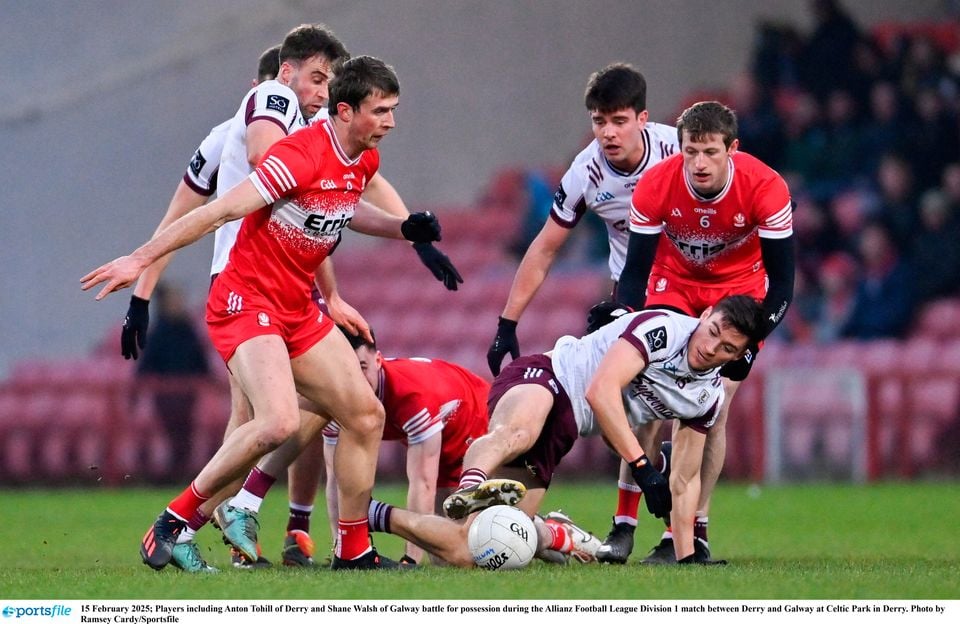 Anton Tohill of Derry and Shane Walsh of Galway battle for possession