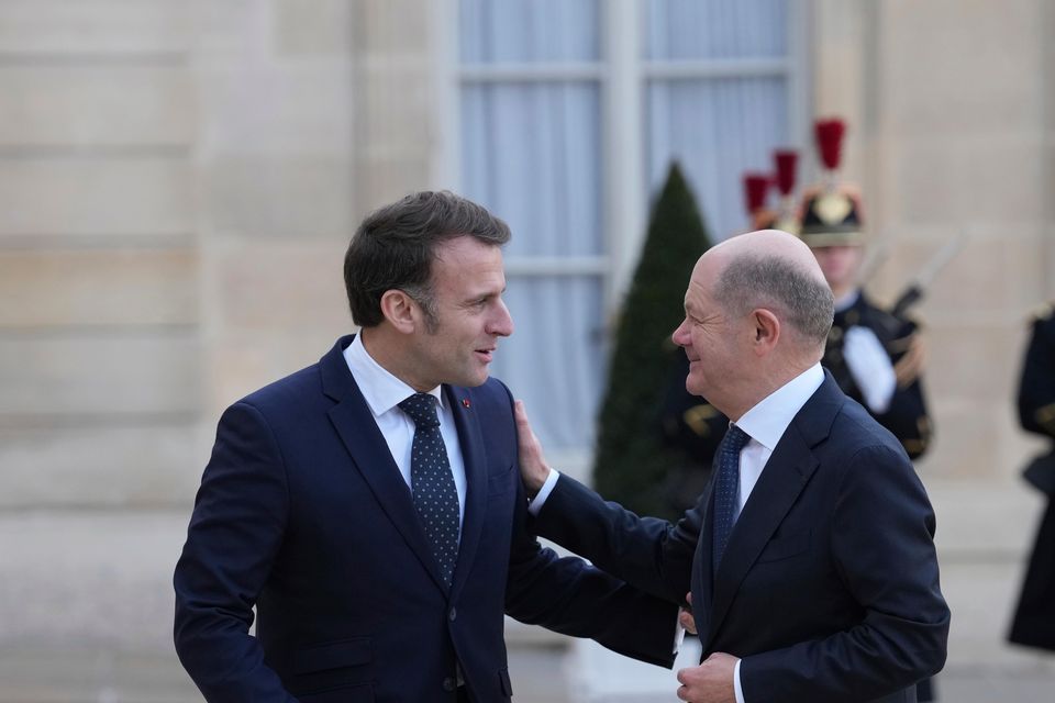 French President Emmanuel Macron, left, greets Germany’s Chancellor Olaf Scholz as he arrives for an informal meeting of leaders from key European Union nations and the United Kingdom at the Elysee Palace in Paris, Monday, Feb. 17, 2025. (AP Photo/Aurelien Morissard)