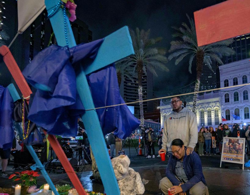 Large crosses have been erected in honour of those who were killed (Matthew Hinton/AP)