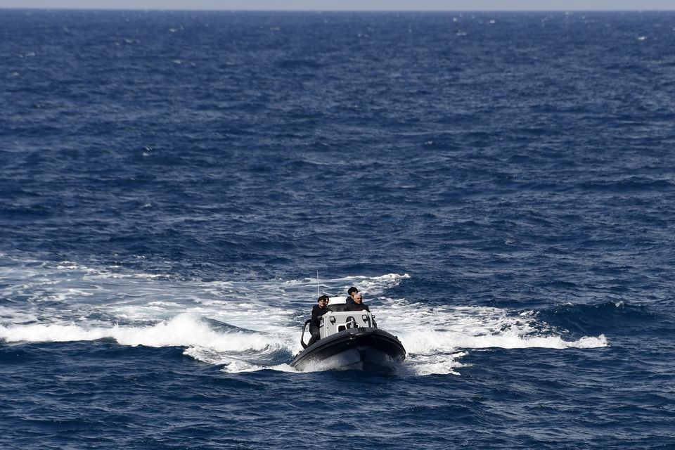 A vessel carrying coast guard officers takes part in a search and rescue operation after a boat carrying migrants ran into trouble off the coast of the island of Samos (Michael Svarnias/AP)