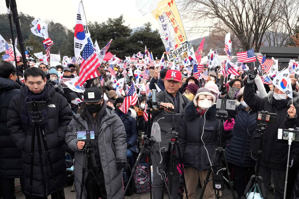 Supporters of Mr Yoon stage a rally to oppose his impeachment outside a detention centre in Uiwang, South Korea, on Thursday (Ahn Young-joon/AP)