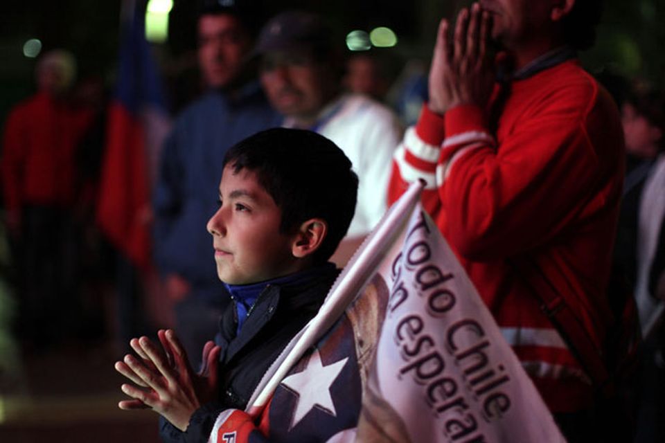 A boy gestures as he watches on TV the rescue operations at the San Jose mine to free 33 trapped miners in Copiapo, Chile, late Tuesday Oct. 12, 2010.  Thirty-three miners became trapped when the gold and copper mine collapsed on Aug. 5. (AP Photo/Dario Lopez-Mills)