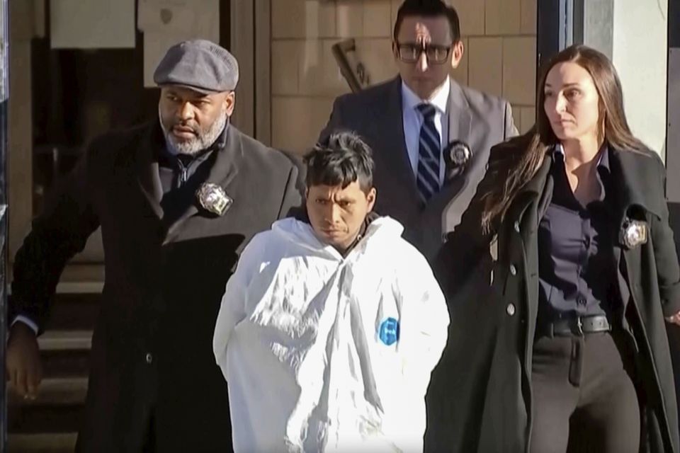 A suspect, identified by police as Sebastian Zapeta, accused in the burning death of a woman on a New York subway, is escorted by police (AP)