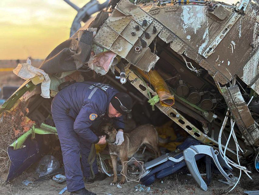 A rescuer searches the wreckage of the Azerbaijan Airlines Embraer 190 (Kazakhstan’s Emergency Ministry Press Service/AP)