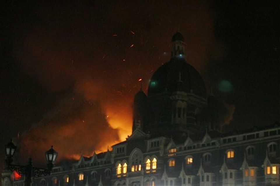 Fire engulfs a part of the Taj Hotel in Mumbai, India, Thursday, Nov. 27, 2008. Teams of heavily armed gunmen stormed luxury hotels, a popular restaurant, hospitals and a crowded train station in coordinated attacks across India's financial capital Wednesday night, killing at least 78 people and taking Westerners hostage, police said. (AP Photo/Gautam Singh)