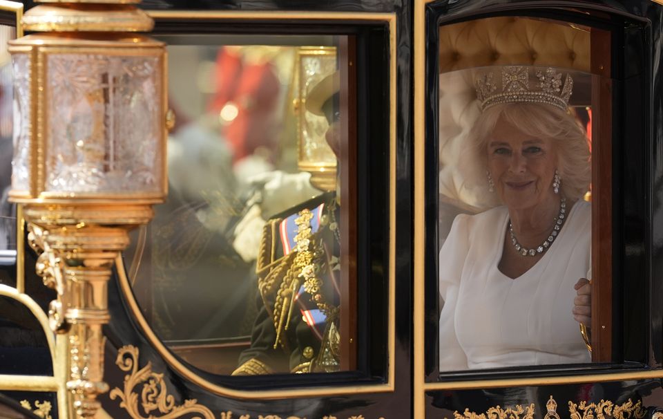 The Queen smiles as she leaves the Palace in procession to the House of Lords (Andrew Matthews/PA)