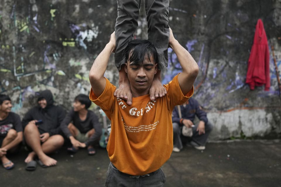 Members of dragon dance club Naga Merah Putih train ahead of the celebrations (Dita Alangkara/AP)