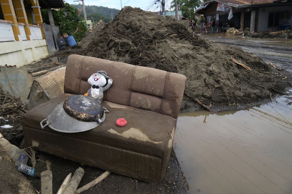 A rabbit doll sits on a mud-covered sofa after a landslide triggered by Tropical Storm Trami struck homes in Talisay, Batangas province (AP Photo/Aaron Favila)