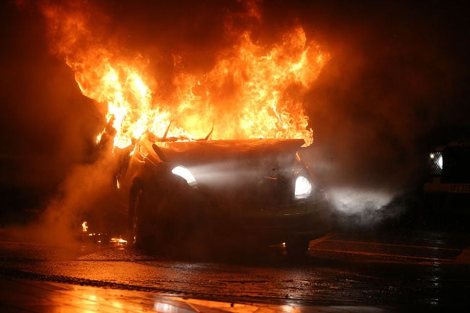 Press Eye - Belfast - Northern Ireland - Sunday 6th  January 2013 - A car burns in the Castlereagh Street of east Belfast this evening following a loyalist protest.A campaign of street demonstrations has been ongoing since Belfast City Council took a vote on 3 December which limited the number of days the union flag is flown at Belfast City Hall.Picture by Kelvin Boyes / Press Eye.