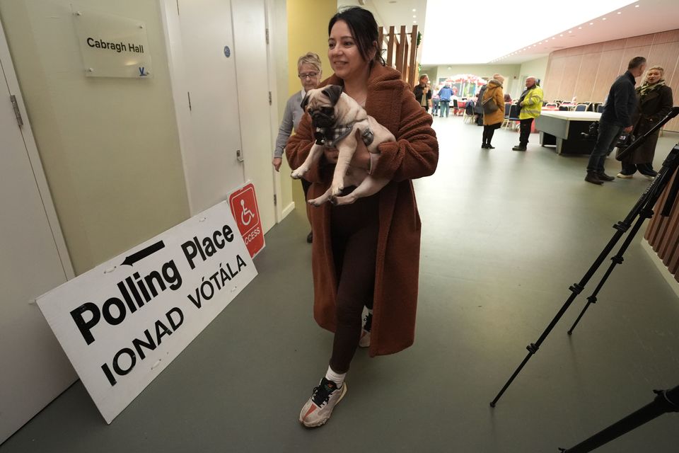 Sonia Higgins, with her pet pug named Chico, arrives to cast her vote at Deaf Village Ireland (DVI) on Navan Road, Dublin (Brian Lawless/PA)