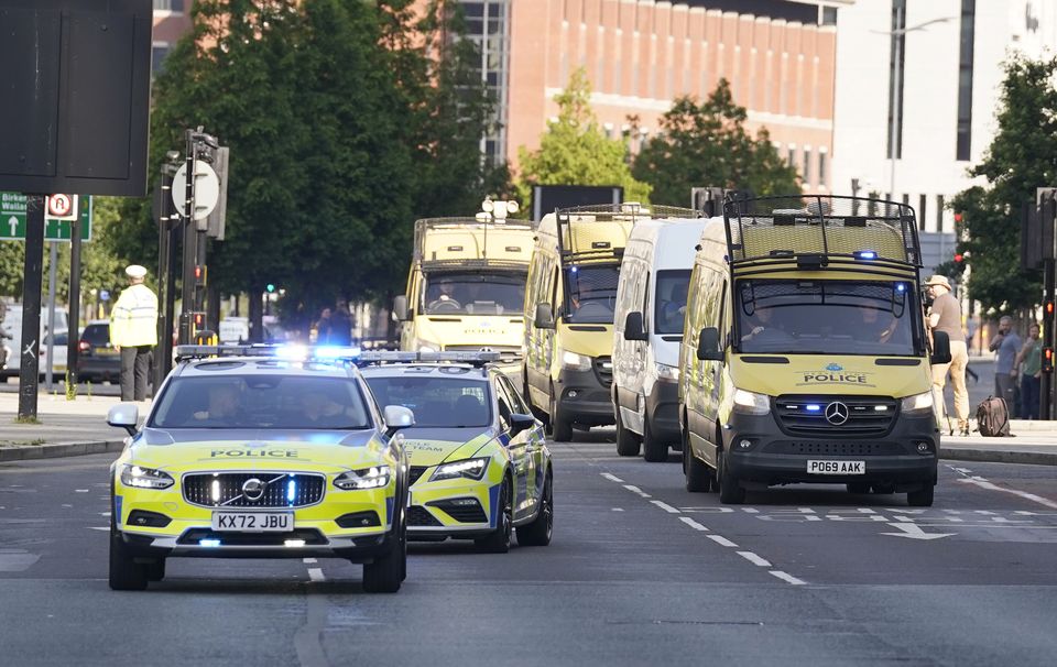 A prison van escorted by multiple police vehicles arrives at Liverpool Magistrates’ Court (Danny Lawson/PA)