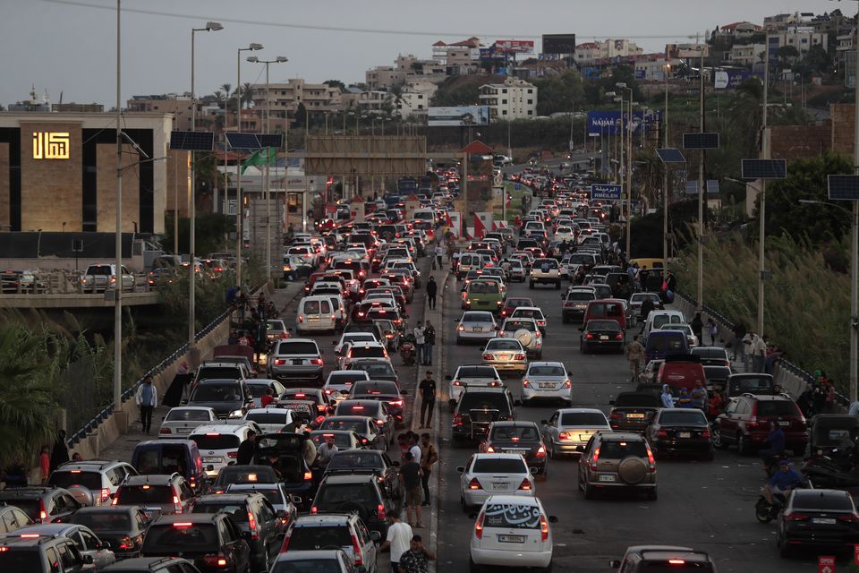 People who fled the southern villages amid ongoing Israeli airstrikes on Monday sit in their cars as they are stuck in traffic at a highway that links to Beirut, in the southern port city of Sidon, Lebanon, on Tuesday (Mohammed Zaatari/AP)