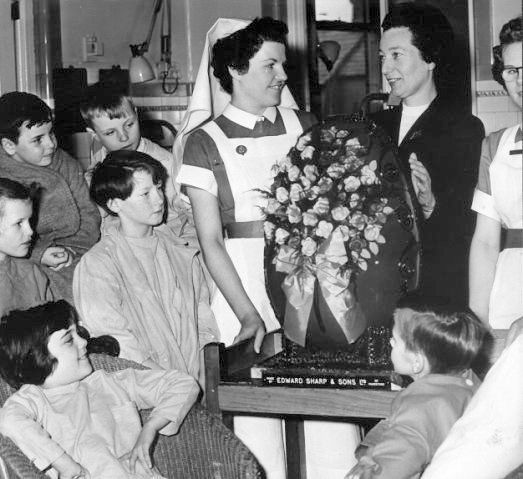 March 1959: Young patients at the Royal Belfast Hospital for Sick Children admire the giant Easter egg, donated by Littlewood's stores