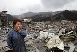 thumbnail: Reiko Miura, 68, cries as she looks for her sister's son at a tsunami-hit area in Otsuchi, northern Japan
