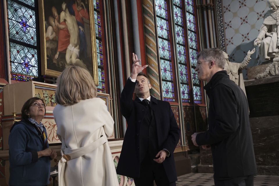 French President Emmanuel Macron looks around the cathedral (Christophe Petit Tesson, Pool via AP)