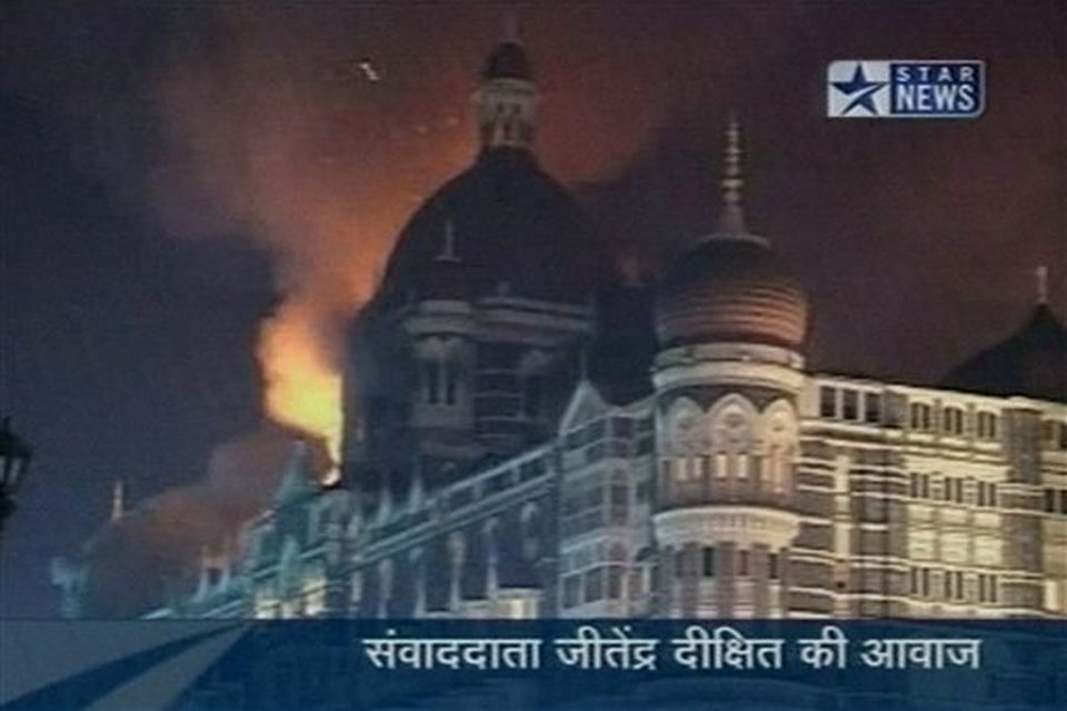 Flames and smoke erupt from the Taj Mahal hotel in Mumbai, India in this image made from television, Wednesday, Nov. 26, 2008. Teams of heavily armed gunmen stormed luxury hotels, a popular restaurant and a crowded train station in coordinated attacks across India's financial capital Wednesday night, killing at least 78 people and taking Westerners hostage, police said. A previously unknown group, apparently Muslim militants, took responsibility for the attacks. A raging fire and explosions struck one of the hotels, the landmark Taj Mahal, early Thursday.  (AP Photo/STAR NEWS)  **  INDIA OUT  TV OUT  **