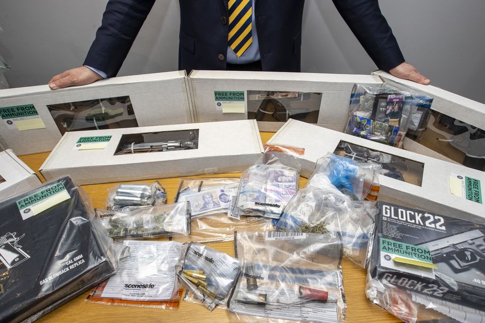 Cash, replica guns, nitrous oxide canisters and cannabis during a press conference at Grosvenor Road PSNI station in Belfast on February 6, 2023. (PA)