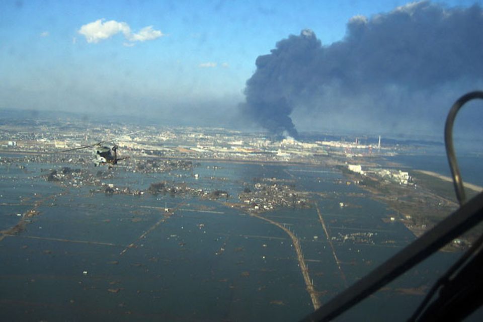 In this March 12, 2011 photo provided by the U.S. Navy, an SH-60B helicopter assigned to the Chargers of Helicopter Antisubmarine Squadron (HS) 14 from Naval Air Facility Atsugi flies over the city of Sendai, Japan to deliver more than 1,500 pounds of food to survivors of an 8.9 magnitude earthquake and a tsunami. The citizens of Ebina City, Japan, donated the food, and HS-14 is supporting earthquake and tsunami relief operations in Japan as directed. (AP Photo/U.S. Navy)