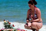 thumbnail: Tourists look at flowers that have been laid on the beach near the RIU Imperial Marhaba hotel in Sousse, Tunisia, as British holidaymakers defy the terrorists and continue to stay in Sousse despite the bloodbath on the beach. PRESS ASSOCIATION Photo. Picture date: Tuesday June 30, 2015. The sands at Sousse were quiet and calm today as tourists and locals alike continued to pay their respects to the 38 dead outside the RIU Imperial Marhaba and Bellevue hotels. Flowers continue to be laid at three heart-shaped memorials that mark where so many people lost their lives, with many people in tears as theyy read the messages of support in several languages that have been placed in the sand. See PA story POLICE Tunisia Tourists. Photo credit should read: Steve Parsons/PA Wire