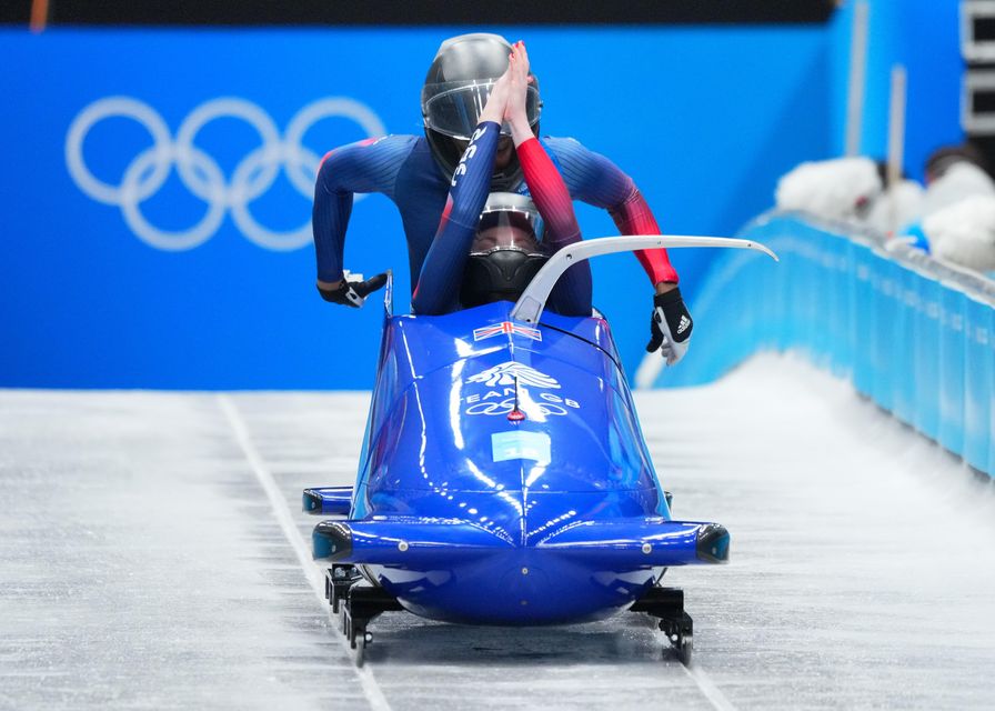 Montell Douglas (back) competing with pilot Mica McNeil at the 2022 Winter Olympics (Michael Kappeler via DPA/PA)