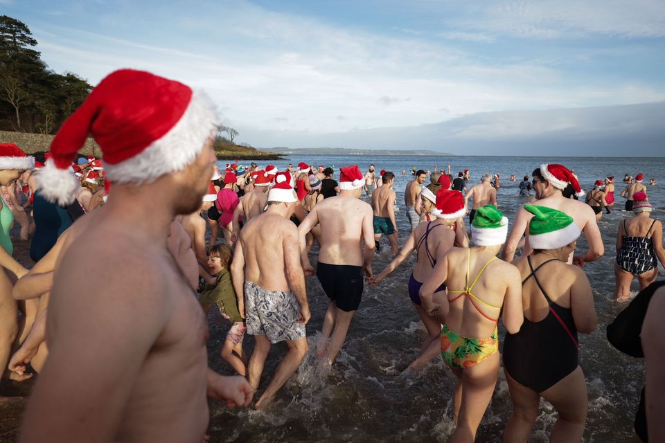 Swimmers take part in the annual Helens Bay Christmas Eve dip at Helens Bay beach, Co Down on December 24, 2023 (Credit: Kelvin Boyes / Press  Eye)