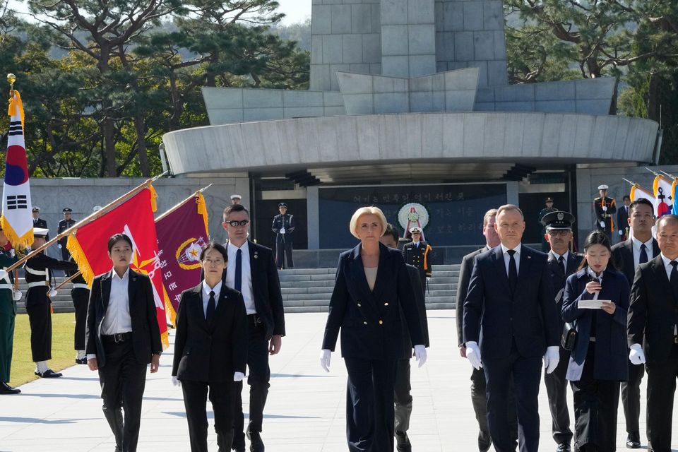 Polish President Andrzej Duda and his wife Agata Kornhauser-Duda visit the National Cemetery in Seoul, South Korea (Ahn Young-joon/AP)