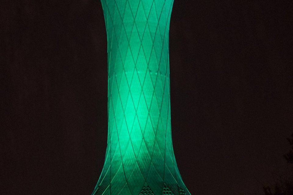 Edinburgh Airport control tower in Scotland illuminated green as it is among more than 100 international landmarks turning green to mark St Patrick's Day.
