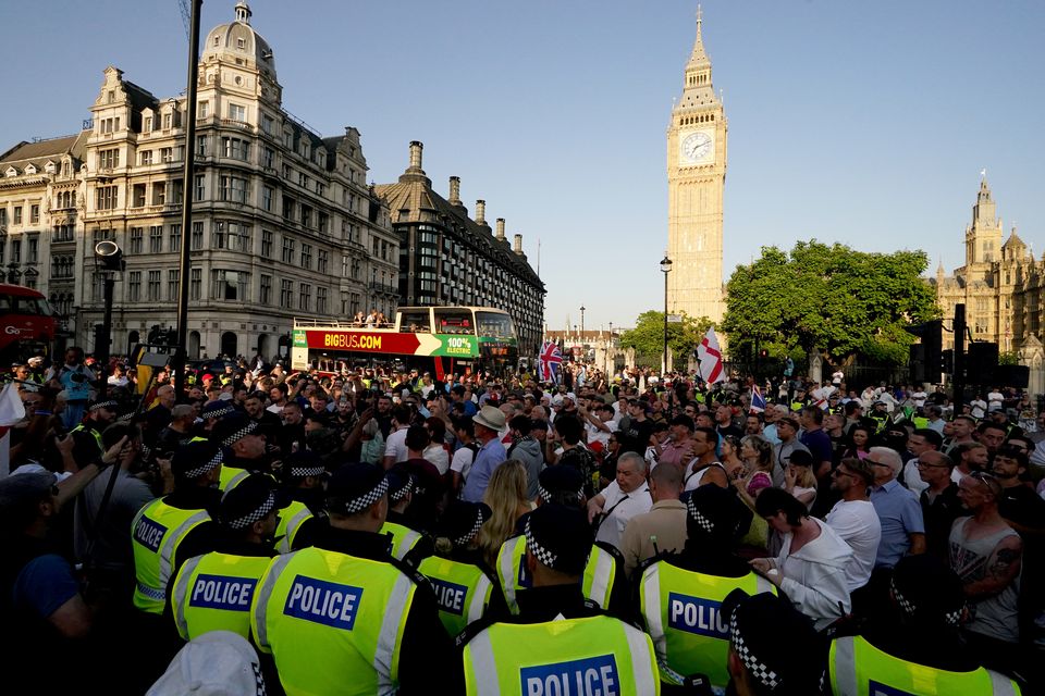 People attending the Enough is Enough protest in Parliament Square, London, following the fatal stabbing of three children at a Taylor Swift-themed holiday club on Monday in Southport (Jordan Pettitt/PA)