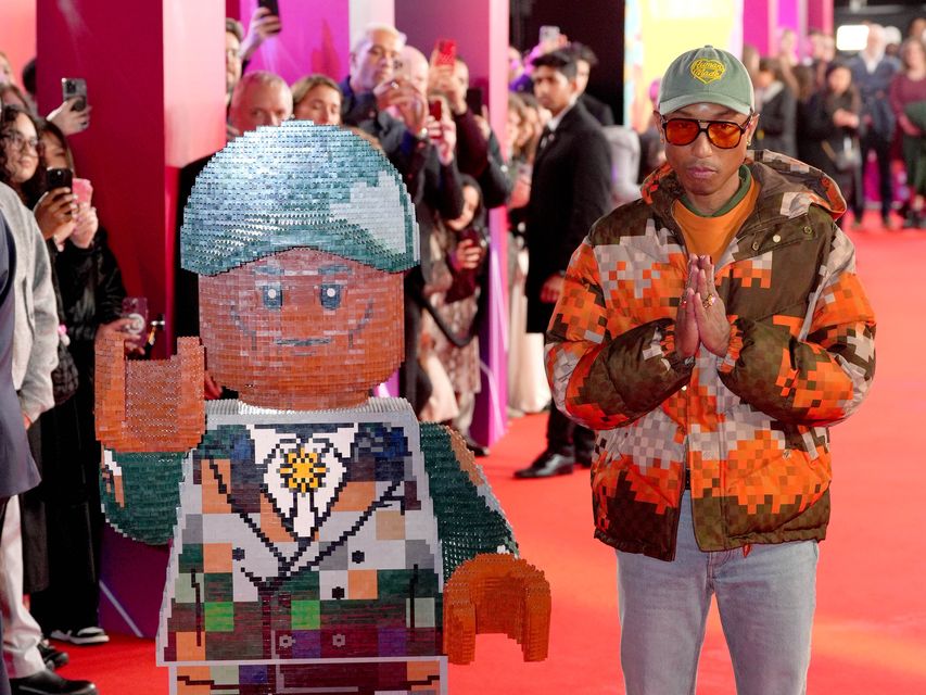 Pharrell Williams stands next to a cut-out Lego figure (Jonathan Brady/PA)