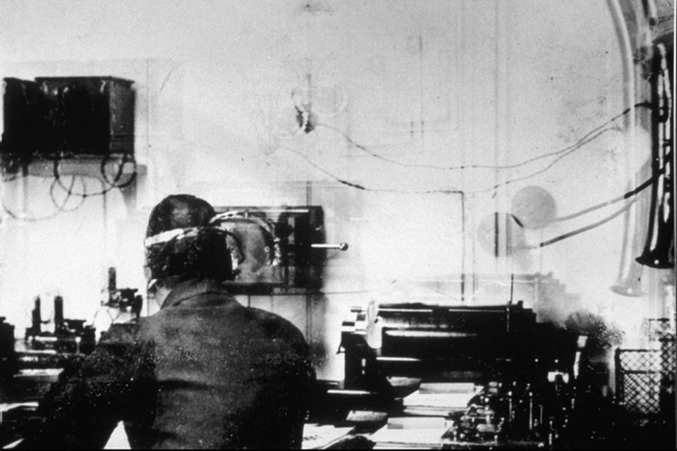 Marconi Room on RMS Titanic showing Harold Bride in a picture taken by Father Browne.