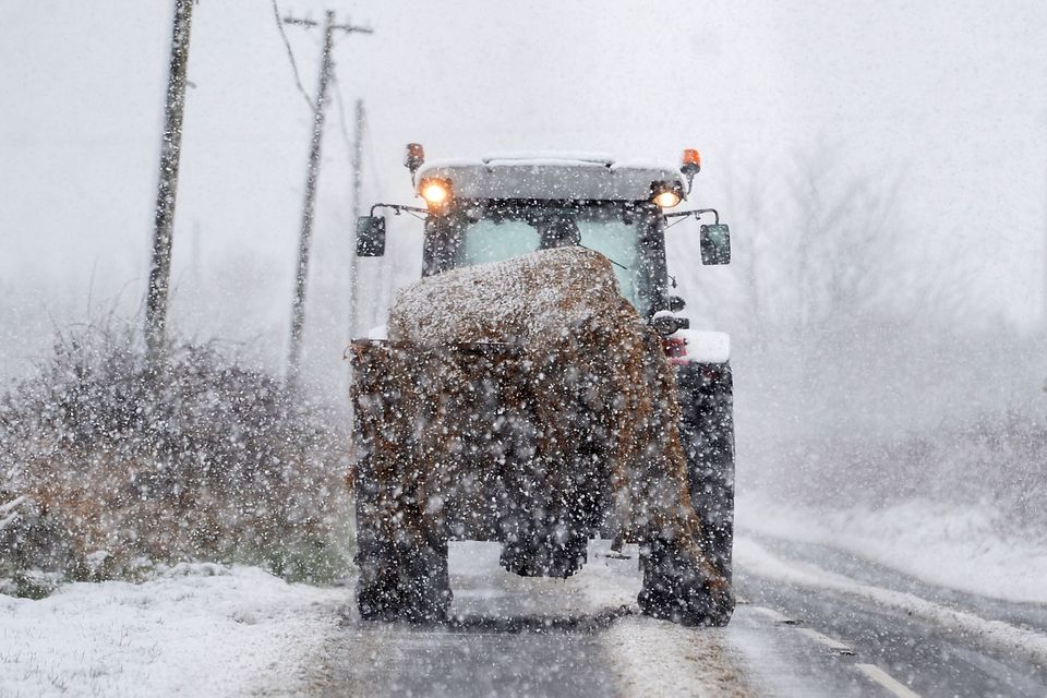 A farmer battles through the snow on the outskirts of Armoy in Northern Ireland. Photo Colm Lenaghan/Pacemaker Press