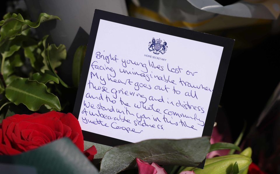 A message in a bouquet of flowers from Home Secretary Yvette Cooper near the scene in Hart Street, Southport (James Speakman/PA) 