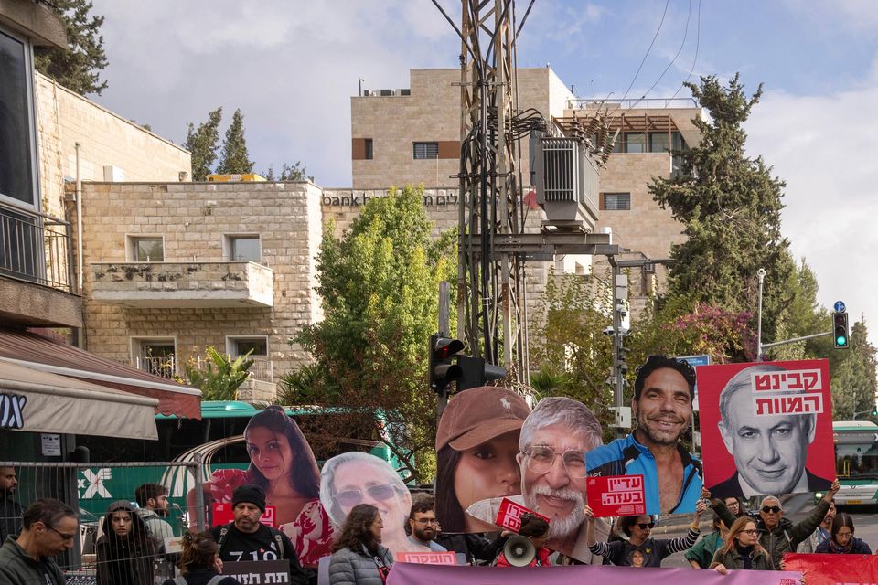 Families and supporters of Israeli hostages held by Hamas in Gaza, hold photos of their loved ones during a protest calling for their release (Ohad Zwigenberg/AP)