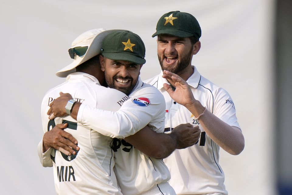 Pakistan’s Aamer Jamal, right, celebrates after taking the catch of England’s Ollie Pope (Anjum Naveed/AP)