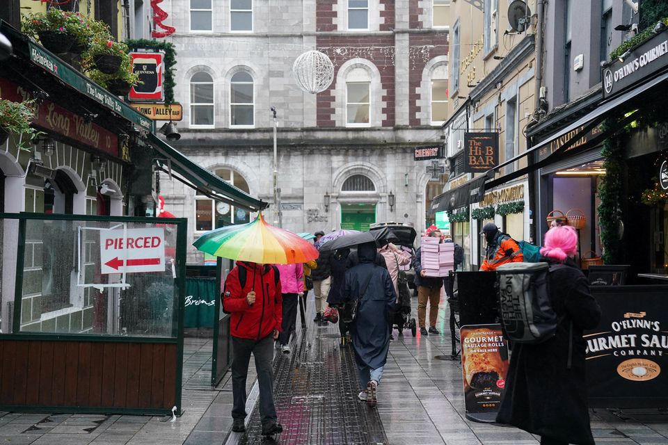 People walk through Cork city centre ahead of the General Election on Friday (Jacob King/PA)