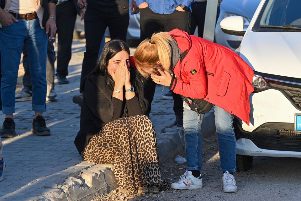 People gather outside of Turkish Aerospace Industries Inc on the outskirts of Ankara (AP)