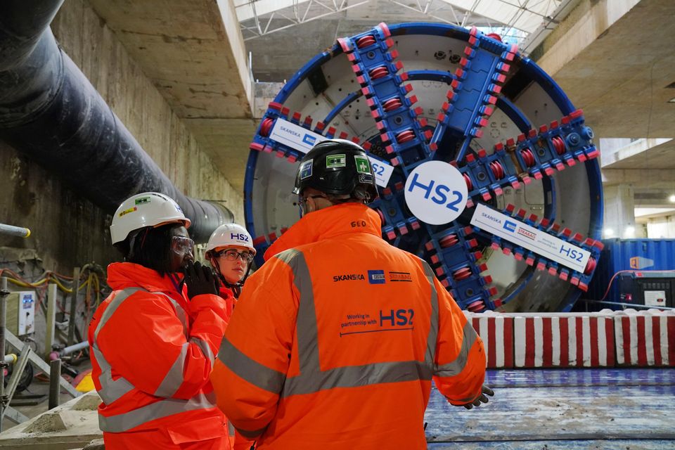 HS2 workers stand in front of tunnel boring machine Karen (Jonathan Brady/PA)