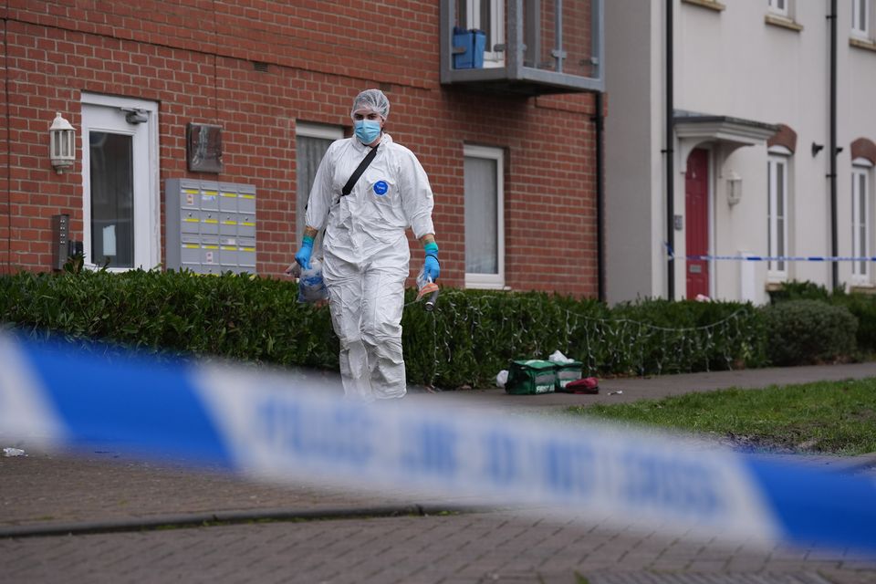 A police cordon and a forensic officer at the scene in Newton Leys (Joe Giddens/PA)