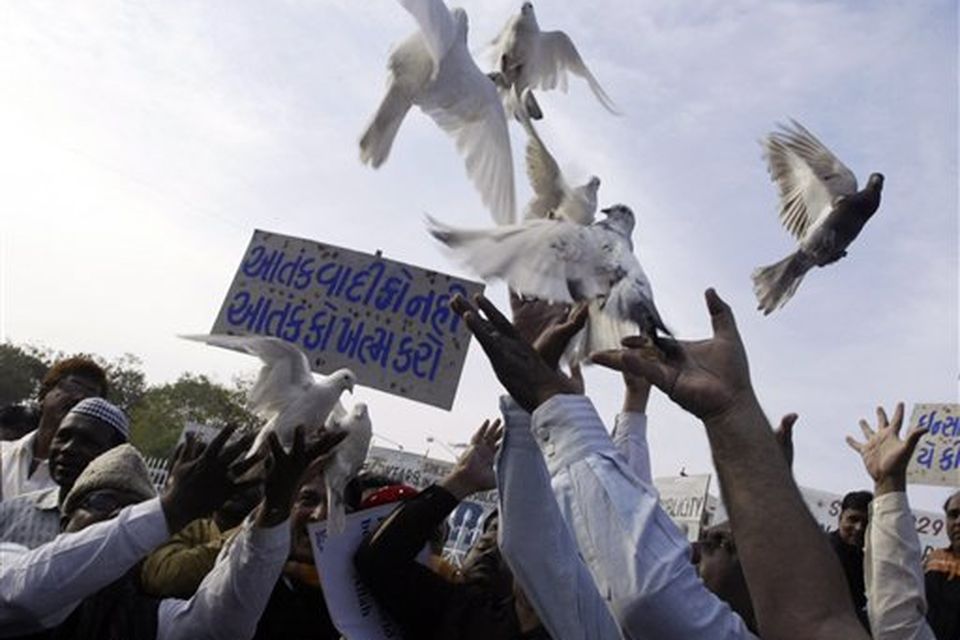 Indian Muslims, release  pigeons during a protest against terrorist attacks in Mumbai, as a placard reads " Kill terror not terrorist " in Ahmadabad, India, Saturday, Nov. 29, 2008. Indian commandos killed the last remaining gunmen holed up at a luxury Mumbai hotel Saturday, ending a 60-hour rampage through India's financial capital by suspected Islamic militants that killed people and rocked the nation. (AP Photo/Ajit Solanki)