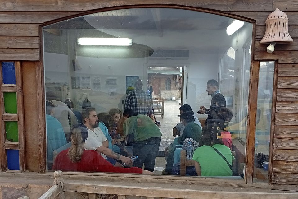 Survivors rest at a coffee shop in Marsa Alam (AP)