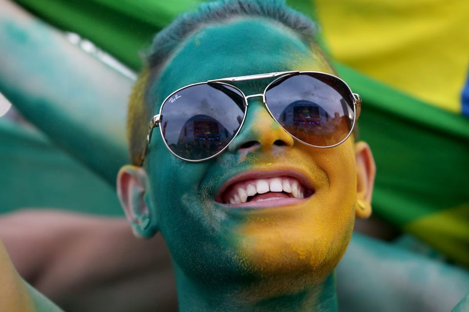RIO DE JANEIRO, BRAZIL - JUNE 23:  A Brazilian soccer fan waits for their team to play against Cameroon at the FIFA Fan Fest on Copacabana beach June 23, 2014 in Rio de Janeiro, Brazil.  (Photo by Joe Raedle/Getty Images)
