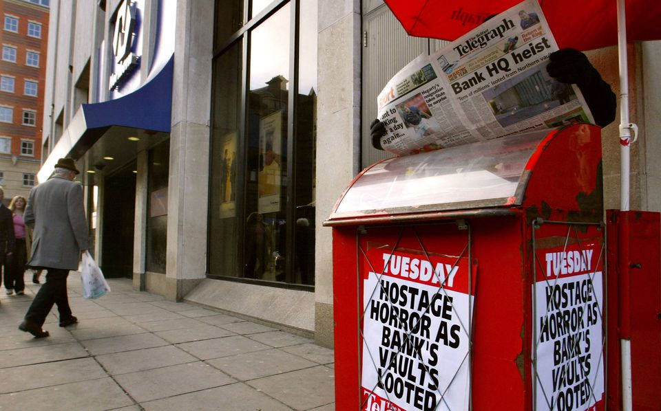 Newspaper seller outside Northern Bank, Belfast, days after the robbery in December 2004. Photo: AP via Getty