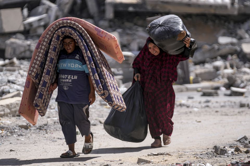 Palestinians displaced by an Israeli air and ground offensive on the Gaza Strip over the weekend (Abdel Kareem Hana/AP)