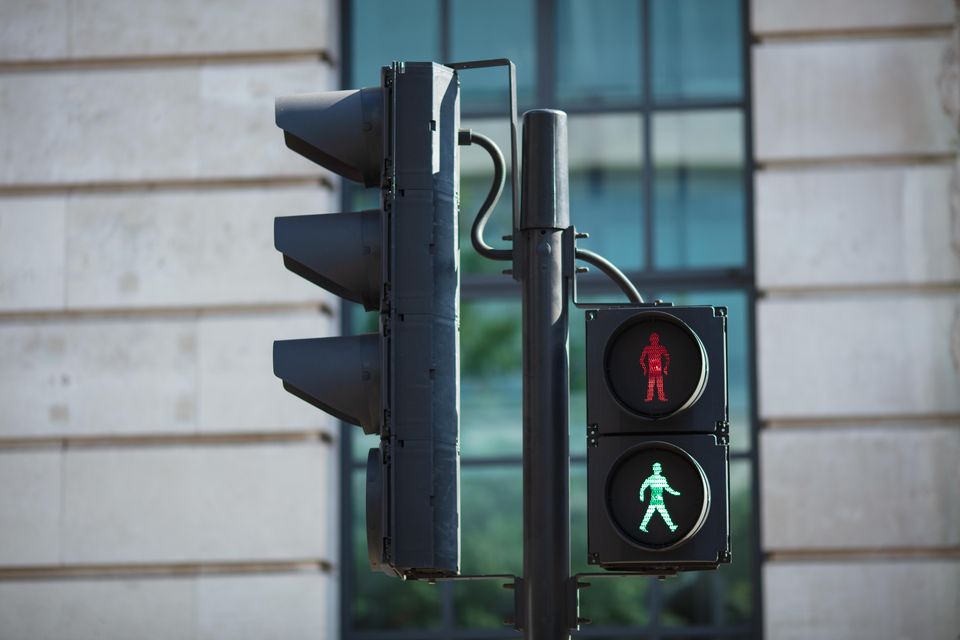 Pedestrian crossing lights with walk and stop symbols