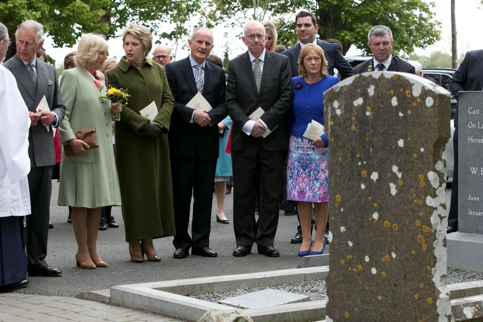 The Prince of Wales (2nd left) and The Duchess of Cornwall (3rd left) at the grave of WB Yeats after attending a peace and reconciliation prayer service at St. Columba's Church in Drumcliffe on day two of a four day visit to Ireland. PRESS ASSOCIATION Photo. Picture date: Wednesday May 20, 2015. See PA story ROYAL Ireland. Photo credit should read: Colm Mahady/PA Wire