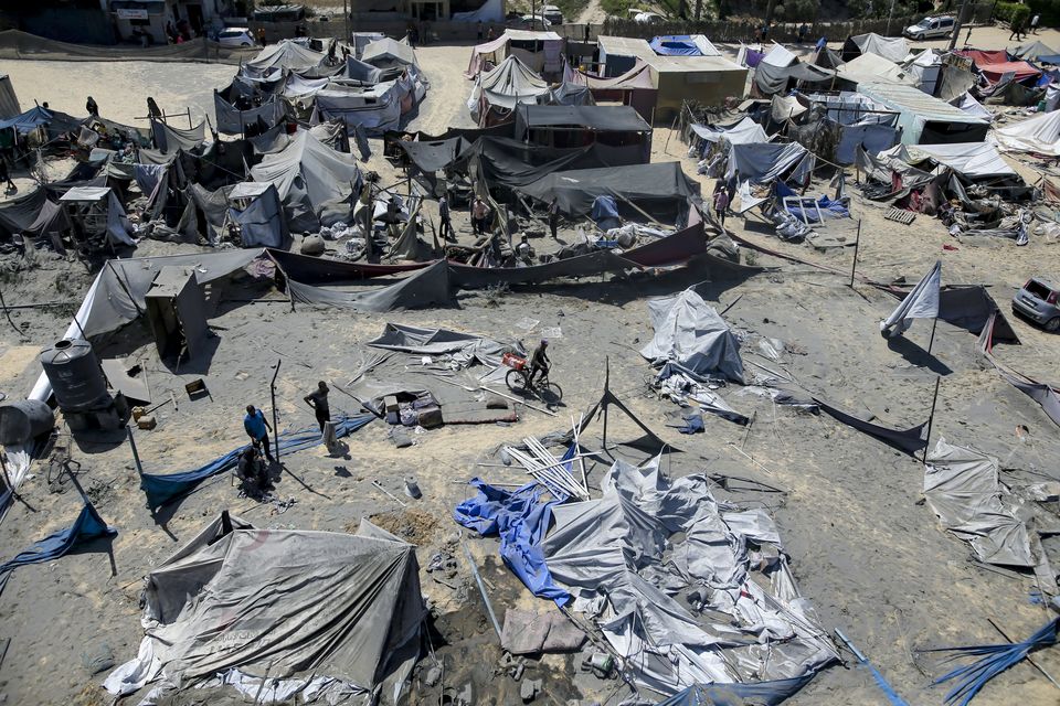 Palestinians inspect the damage at a site after an Israeli bombardment on Khan Younis (Jehad Alshrafi/AP)